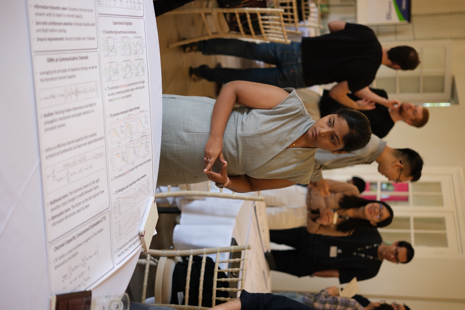 Researchers discussing posters together