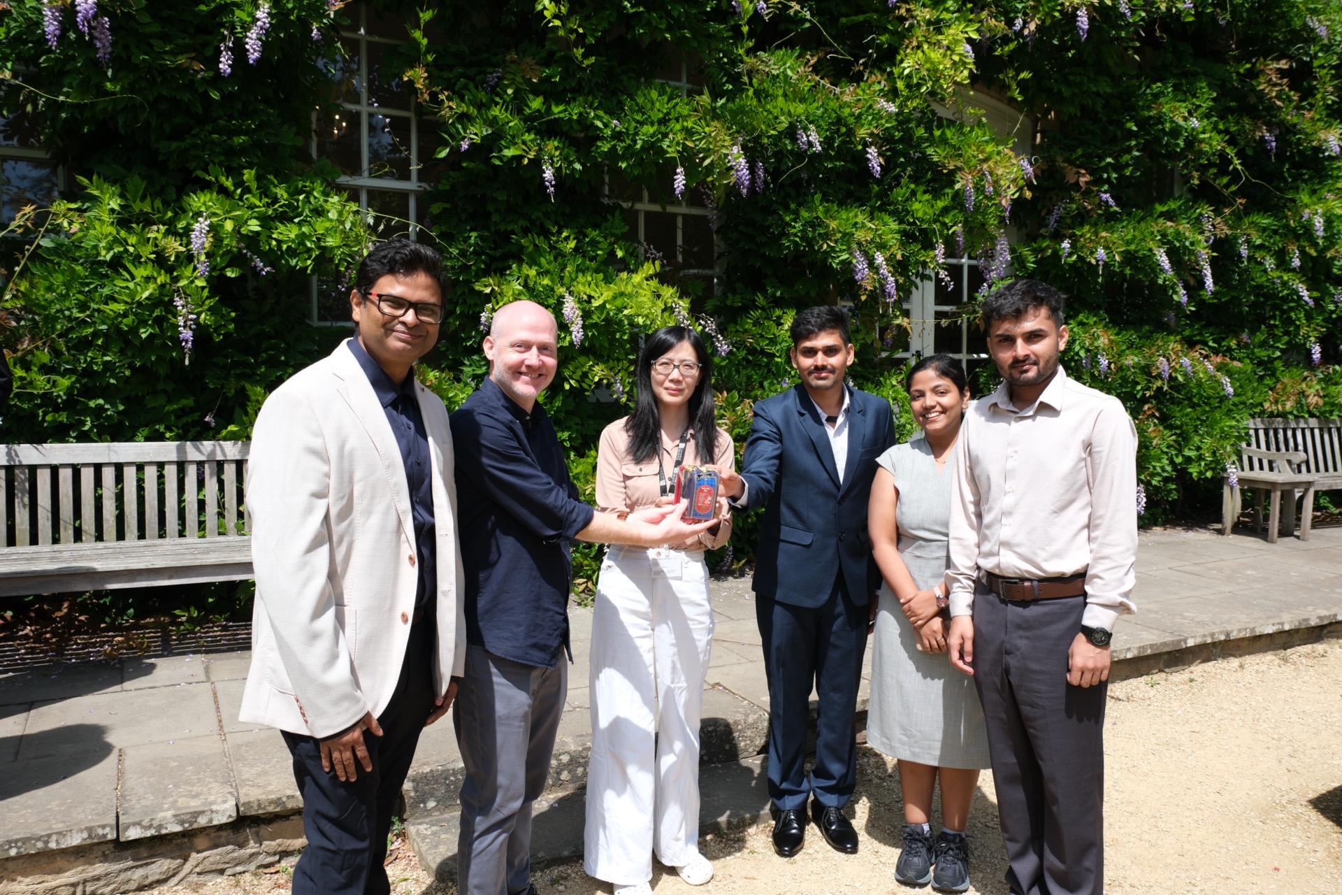 IIT Bombay team presenting a commemorative gift to Prof John Cartlidge and Dr Jin Zheng in the Goldney Hall garden